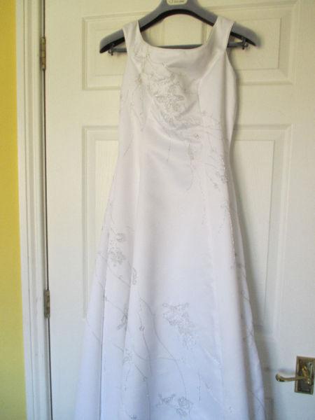 beautiful white wedding dress with silver thread detail and train