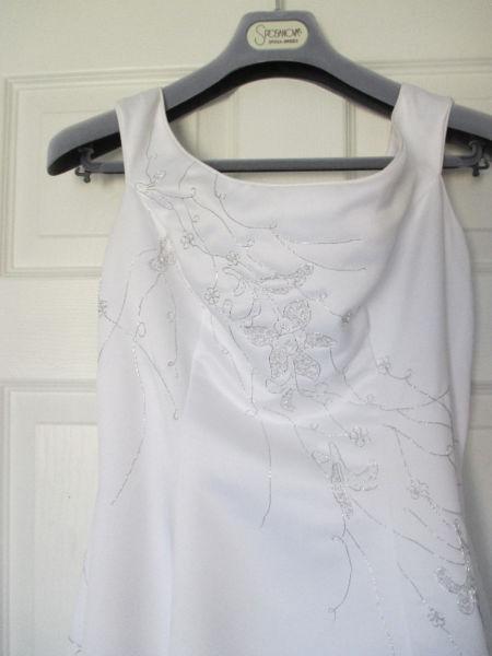 beautiful white wedding dress with silver thread detail and train