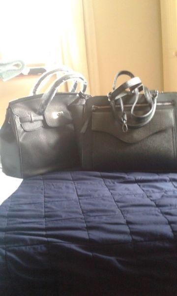 two black strapless handbags