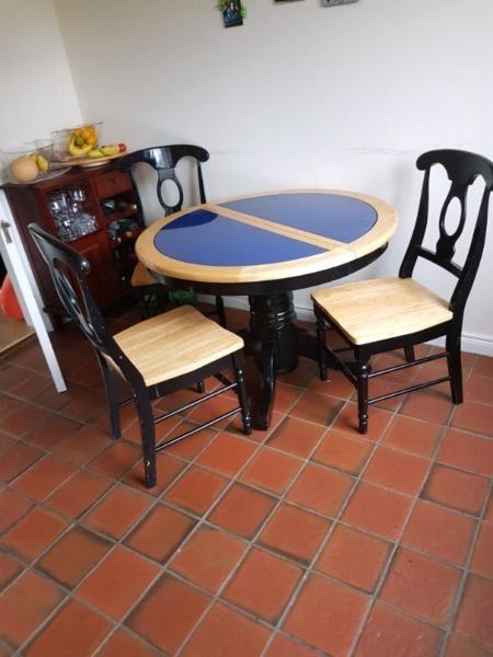 Round rustic dining table and four chairs