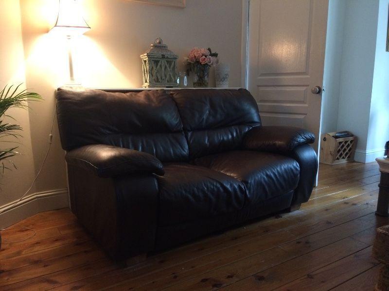 Two brown leather sofas