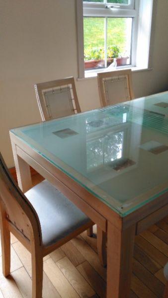 Stunning wood and glass table with six white chairs