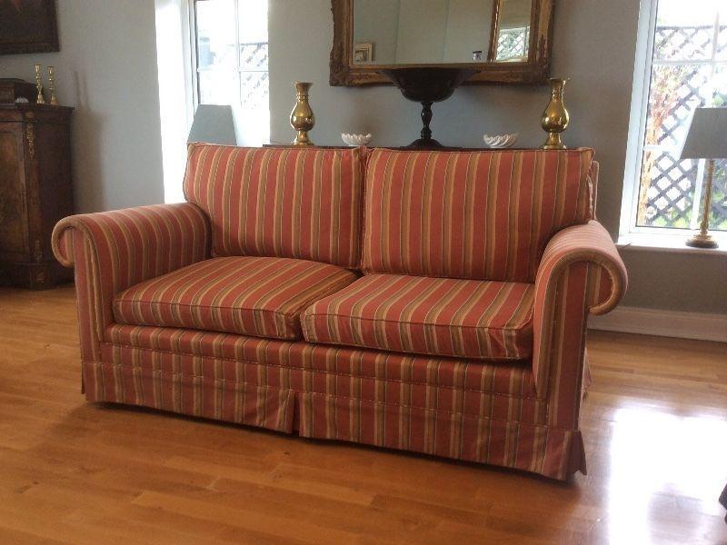 Two identical two seater couches / sofas
