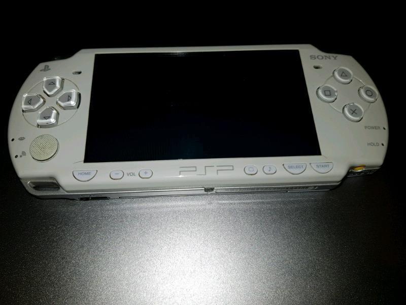 PSP + Charger + metal case + games