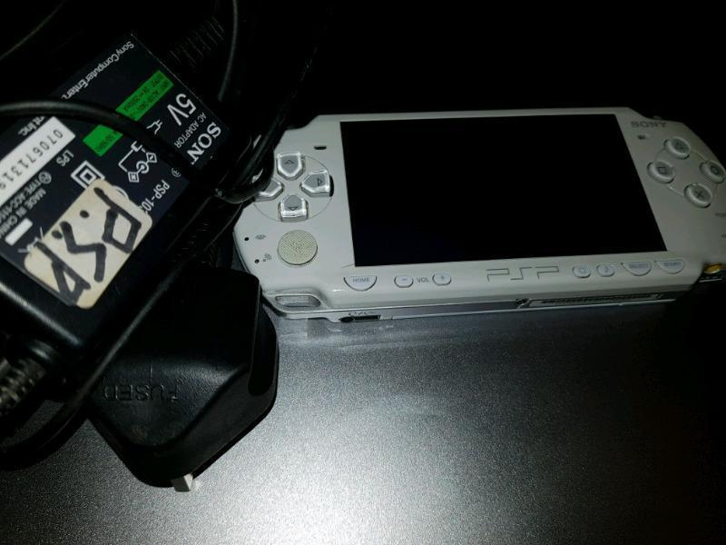 PSP + Charger + metal case + games