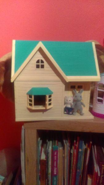 Sylvanian cottage and three figures