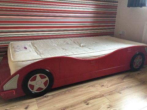 Red racing car bed and shelves