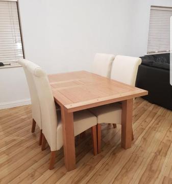 Solid Oak extendable dining table with 4 cream scroll back chairs