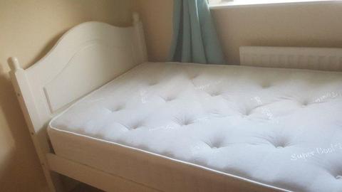 White wooden frame single bed