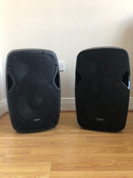 A pair of Kam RZ12A V3 active speakers complete with 2 x tripod stands and carry bag