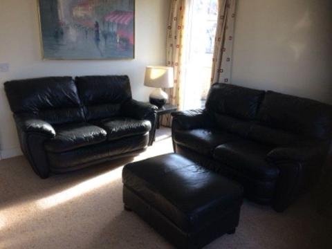 Leather sofas 2 x 2 seater and foot stool