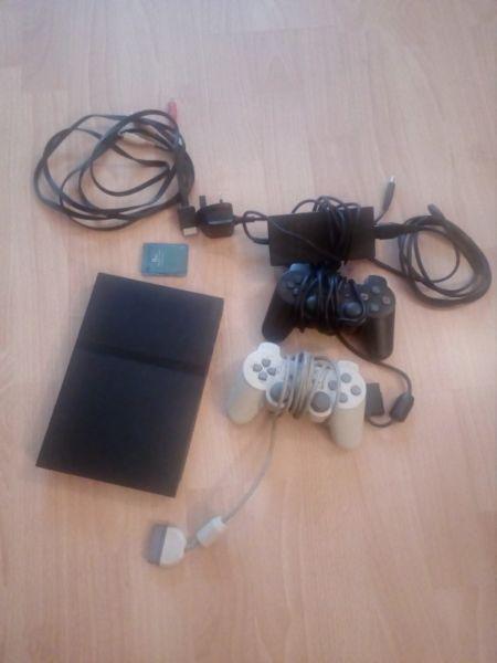 PlayStation 2 Console with 2 Controllers and a selection of games
