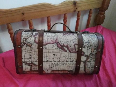 suitcase with the map of the world outside